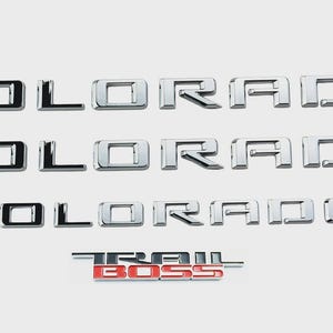 May include: A set of three ceramic mugs with a speckled, matte finish. Each mug features a different color: light blue, cream, and gray. The mugs have a simple, modern design and a comfortable handle.