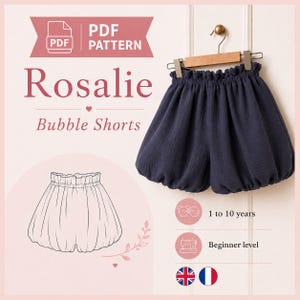 Peut inclure: Un patron PDF pour le short bouffant Rosalie, illustré par un short bleu foncé avec une taille élastiquée à volants et des ouvertures de jambes froncées. Le visuel comprend un dessin au trait du short, du texte et des icônes de niveau.