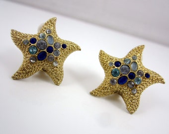 Classy LIZ CLAIRBORNE Star Shape Gold Tone Clip On Earrings with Multi Color Blues Faux Rhinestones