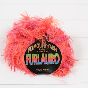 May include: A skein of pink and orange Furlauro yarn from the Plymouth Yarn Italian Collection. The label reads "Plymouth Yarn Italian Collection Furlauro 100% Nylon."