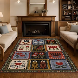 May include: Rectangular area rug with a folk art design. The rug features a repeating pattern of floral and bird motifs in red, blue, and green on a cream background. The rug is bordered with a green and cream floral design.