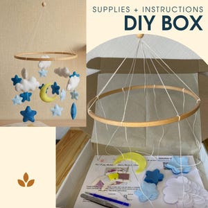 Può includere: Un kit fai-da-te per giostrina da culla con un cerchio in legno, fili bianchi e forme in feltro tra cui nuvole bianche, stelle blu e una luna crescente gialla, completo di istruzioni stampate, aghi e filo per l'assemblaggio.
