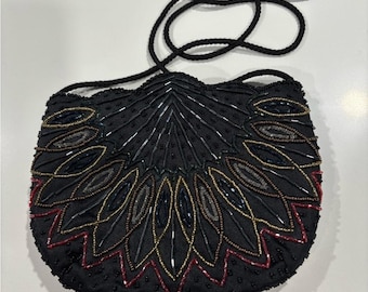 Bolso de cuentas La Regale LTD, cuentas multicolores sobre fondo negro.