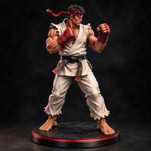 Könnte beinhalten: Eine muskulöse Actionfigur eines Kampfsportlers in einem weißen Gi mit ausgefransten Rändern, einem schwarzen Gürtel mit goldenen japanischen Schriftzeichen und roten Handschuhen. Die Figur trägt ein rotes Stirnband und steht auf einem schwarzen Sockel.