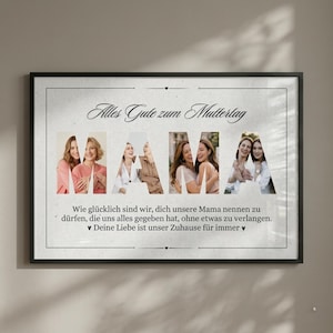 May include: Framed print with the word "MAMA" formed by photos of women. The text "Alles Gute zum Muttertag" is at the top, with additional text below. The frame is black, and the background is a light beige.