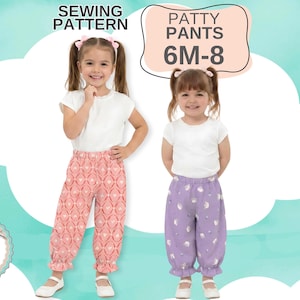 May include: A sewing pattern for Patty Pants in sizes 6M-8. The image displays two pairs of pants: one in a coral pink fabric with a white geometric heart pattern and another in a light purple fabric with a white circular pattern, both featuring elasticized waistbands and ruffled cuffs.