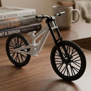 May include: A miniature bicycle model featuring a white frame and black components, including the handlebars, front fork, and spoked wheels. The bicycle has a small seat and pedals, showcasing a detailed design with a high-contrast colour scheme.