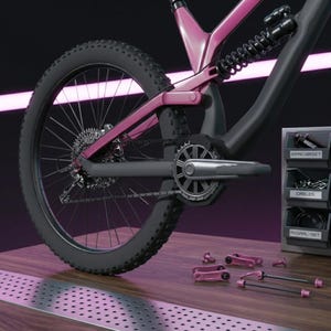 May include: A contemporary mountain bike featuring a pink frame and black tyres. The bike is presented on a wooden surface with a metal grate. Bike components are arranged nearby, including a "KANGARSET" and "CABLES" storage unit.