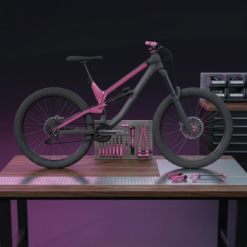 May include: A grey and pink mountain bike with black tyres and a black seat. The bike is on a wooden workbench with pink tools and a pegboard. The background is dark.