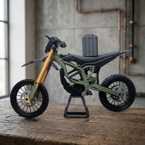 May include: A miniature olive green dirt bike model featuring gold-colored front forks, black spoked wheels with disc brakes, a black seat, and a vertical grey battery pack mounted on the frame, all supported by a black metal display stand.