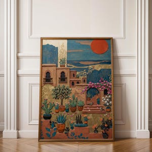 May include: A framed artwork depicting a desert landscape with buildings, cacti, and a large red sun. The artwork features a variety of colors, including blues, oranges, and greens, and is displayed against a white wall with wooden flooring.