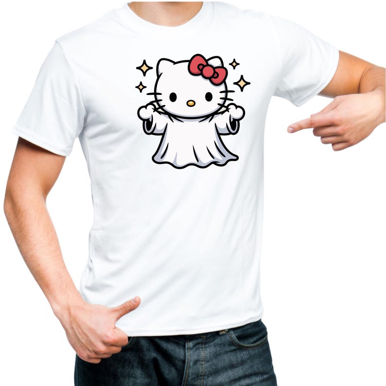 May include: White t-shirt featuring a cartoon illustration of a ghost version of a popular cat character with a red bow. The design includes sparkling stars. The shirt is a casual wear item.