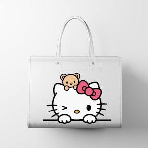 May include: White tote bag featuring a Hello Kitty graphic with a pink bow and a small teddy bear. The bag has two handles and a simple, clean design, perfect for carrying everyday items. The Hello Kitty design is in black, pink, and yellow.