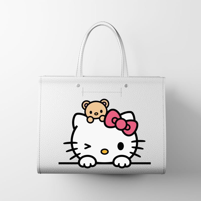 May include: White tote bag featuring a Hello Kitty graphic with a pink bow and a small teddy bear. The bag has two handles and a simple, clean design, perfect for carrying everyday items. The Hello Kitty design is in black, pink, and yellow.