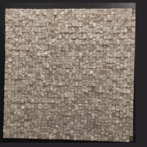 May include: A square mosaic tile sheet composed of numerous small, light beige, rectangular stone pieces arranged in a uniform grid pattern. Each individual stone features a textured, uneven surface, creating a tactile appearance across the entire panel.