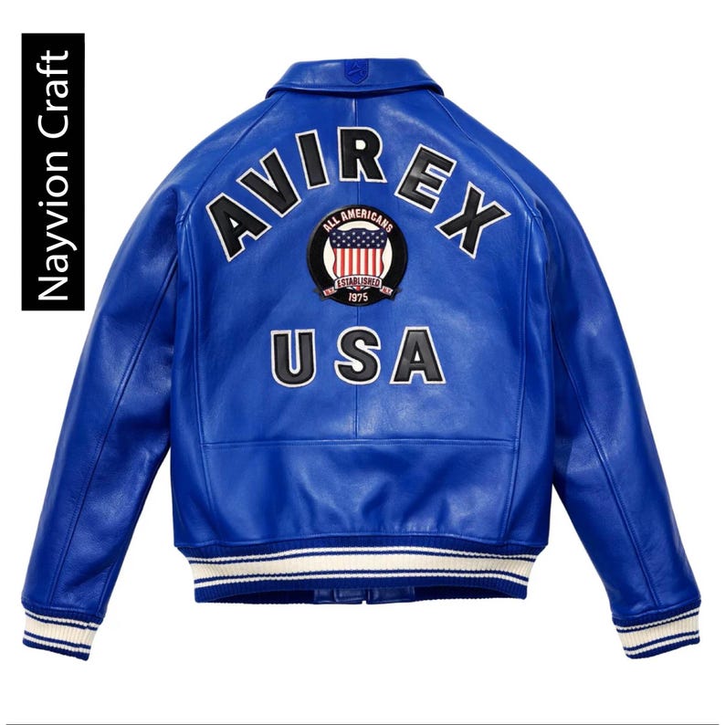 May include: A vibrant blue leather jacket with the word "AVIREX" across the back, along with a patch featuring the American flag and the word "USA". The jacket has a classic bomber style with white and blue striped cuffs and hem.