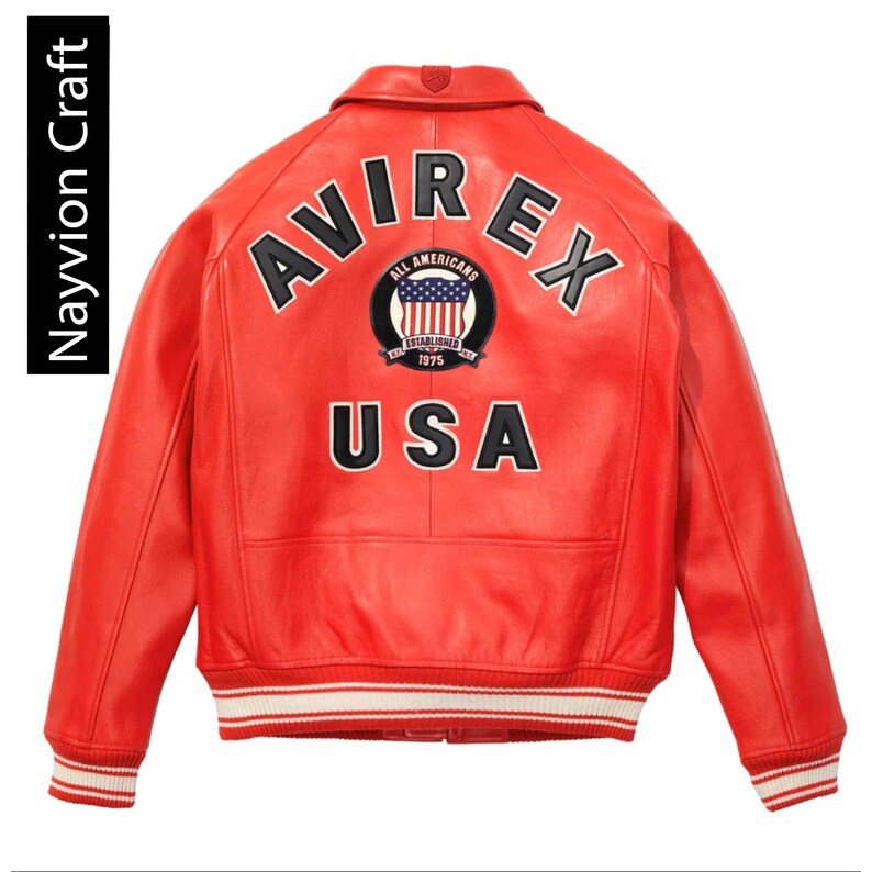 May include: Red leather jacket with the word "AVIREX" arched across the shoulders in white and black lettering. Below the word "AVIREX" is a circular patch with the American flag and the words "ALL AMERICANS ESTABLISHED 1975". The word "USA" is below the patch.
