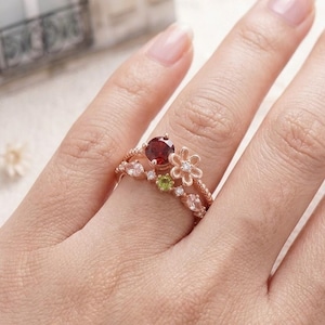 May include: A set of three ceramic canisters with lids, featuring a geometric pattern in shades of blue, white, and gray. The canisters vary in size, with the largest approximately 8 inches tall.