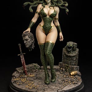 May include: A detailed Medusa statue with snakes for hair, wearing a green and gold bodysuit. The statue holds a severed head and stands on a stone base with a sword and a stone carving. The overall theme is Greek mythology.