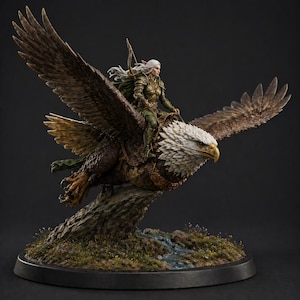 May include: A detailed figurine of a woman riding a large eagle. The woman wears green armor and has long white hair. The eagle has brown and white feathers, with its wings spread wide. The base features a small stream and patches of grass.