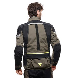 May include: A motorcycle jacket in olive green and black, featuring reflective stripes and a yellow accent line. The jacket has multiple pockets and the brand's logo in yellow. The jacket is designed for protection and visibility.