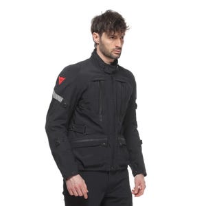 May include: Black motorcycle jacket with multiple pockets, a high collar, and a red logo on the shoulder. The jacket has reflective stripes on the sleeve and a zippered front closure. The jacket appears to be made of a durable, weather-resistant material.