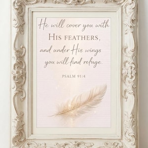 May include: A rectangular wall art print in an ornate, cream-colored vintage frame. The print features a soft pink background with a single light-colored feather and the text: He will cover you with His feathers, and under His wings you will find refuge. PSALM 91:4.