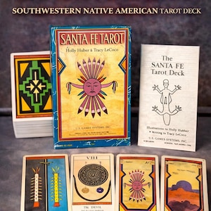 May include: A white ceramic mug with a black handle and the text "But First, Coffee" in a black, bold font. The mug is on a white surface.