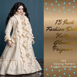 May include: A 38 cm fashion doll in a cream vintage peignoir with ruffled trim. The doll has long black hair and is set against a teal backdrop. Text on the right side reads "15 Inch Fashion Dolls Vintage Glamour Peignoir".