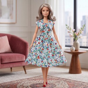 May include: A doll with shoulder-length wavy silver hair wearing a sleeveless dress and a matching cropped jacket. The outfit features a vibrant floral pattern with red, yellow, and blue flowers on a white background. The doll wears red heels.
