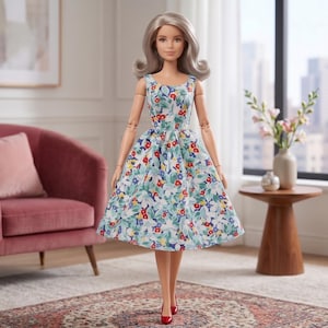 May include: A doll with shoulder-length silver hair wearing a sleeveless dress featuring a colorful floral pattern of red, blue, and yellow flowers with green leaves on a white background, paired with simple red pointed-toe shoes.