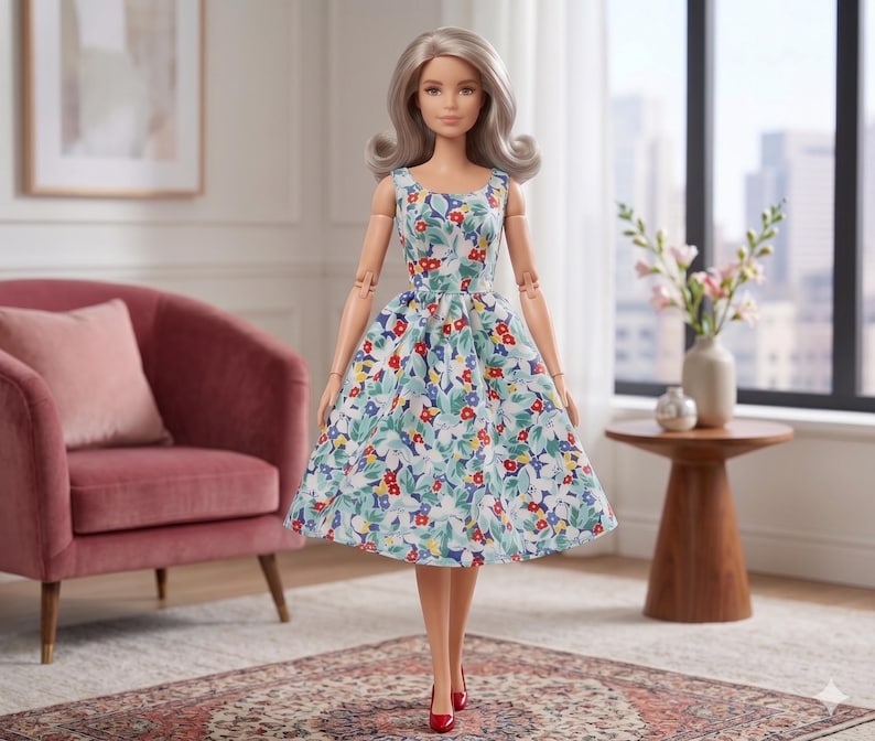 May include: A doll with shoulder-length silver hair wearing a sleeveless dress featuring a colorful floral pattern of red, blue, and yellow flowers with green leaves on a white background, paired with simple red pointed-toe shoes.