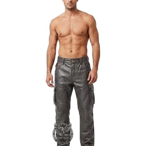 May include: Gray leather cargo pants with multiple pockets. The pants have a button and zipper closure and are made of a soft, supple leather material. The pants are a neutral color and can be paired with many different tops.