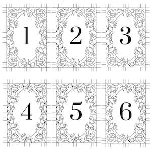 May include: A grid of six rectangular cards, each featuring a black and white line art illustration of a central oval frame surrounded by rose motifs. Each card contains a large, centered black numeral ranging from one to six in a serif font.