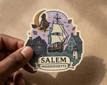 May include: A die-cut sticker featuring a graphic illustration of Salem, Massachusetts. The design includes a sailing ship, a lighthouse, houses, a crescent moon, and a figure on a broomstick against a purple sky with falling autumn leaves.