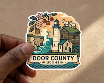 May include: A die-cut sticker featuring a lighthouse, a wooden building with two goats on the roof, cherry blossoms, and cliffs by the sea. The text reads DOOR COUNTY WISCONSIN. The illustration uses a palette of blue, green, tan, and red accents.
