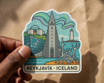 May include: A die-cut sticker featuring a stylized illustration of the Reykjavik skyline in Iceland. The design includes the Hallgrimskirkja church, Harpa concert hall, a lighthouse, and the northern lights against a light blue sky with text.