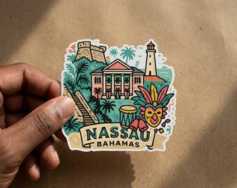May include: A die-cut sticker featuring a colorful illustration of Nassau, Bahamas, including a historic building, a lighthouse, palm trees, a drum, and a festive mask. The text NASSAU BAHAMAS is printed in a dark green font on a light tan banner.