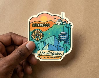 May include: A colorful sticker featuring a Los Angeles, California design. The sticker includes the Hollywood sign, a Ferris wheel, and other iconic landmarks. The text "Hollywood" and "Los Angeles California" are also included.