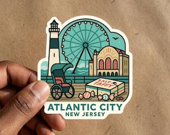 May include: A die-cut sticker featuring a stylized illustration of Atlantic City, New Jersey. The design includes a lighthouse, a Ferris wheel, a rolling chair, and a box labeled Salt Taffy with scattered candies. The text reads Atlantic City New Jersey.