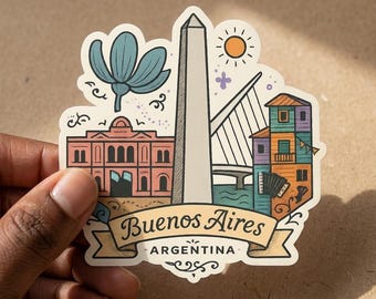 May include: A die-cut sticker featuring a colorful illustration of Buenos Aires, Argentina landmarks including the Obelisk, a pink building, a bridge, and a multi-colored house. The text Buenos Aires Argentina is printed on a banner at the bottom.