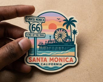 May include: A Santa Monica sticker featuring a sunset, Ferris wheel, palm trees, and pier. The sticker includes the text "Santa Monica" and "California", and a Route 66 sign that reads "End of the Trail".