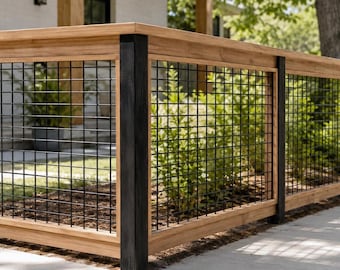 May include: A wooden fence featuring a natural light brown finish with vertical black posts and a black metal grid panel insert. The structure consists of horizontal wooden rails at the top and bottom, framing the square wire mesh sections.