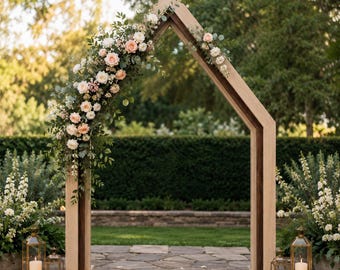 May include: A pentagonal wooden wedding arch featuring a light oak frame with a dark wood inner trim. The left side is adorned with a lush arrangement of peach and white roses, greenery, and eucalyptus. Four gold lanterns with white candles sit below.
