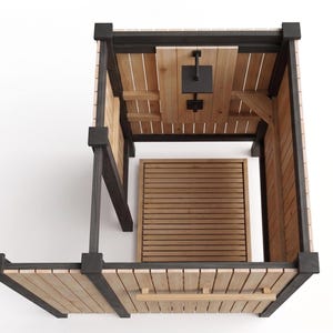 May include: An outdoor shower enclosure featuring natural light-colored wood vertical slats framed by dark charcoal-colored posts. The unit includes a square black shower head mounted on a central panel and a slatted wood floor base for drainage.