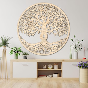 May include: A large, circular wooden wall art piece featuring a detailed tree design. The tree's branches and roots are intricately carved within the circle. The artwork is a light wood color and is mounted on a white wall.