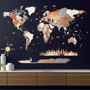 May include: A large wooden world map wall art in shades of brown, gray, and white, mounted on a dark blue wall. Includes decorative elements like a compass rose, ships, and airplanes. The map is a detailed representation of the world.