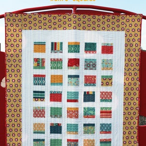May include: A quilting pattern called "Pop Block" that makes five sizes of quilts, from square to king, using 5-inch squares. The pattern is shown on a white quilt with a yellow and red border. The quilt is made with colorful fabric squares in red, yellow, green, and blue.