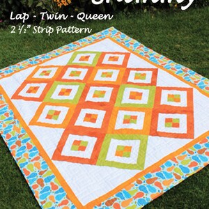 May include: A quilting pattern for a Sunshine Shimmy quilt in lap, twin, or queen sizes. The pattern uses 2 1/2 inch strips and features a colorful geometric design with orange, green, and white squares on a white background. The quilt is surrounded by a blue, green, and orange border with a footprint pattern.