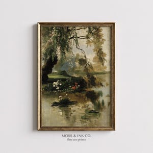 Puede incluir: Impresión artística vintage enmarcada que representa un sereno paisaje acuático con un sauce llorón. La obra presenta un estanque con nenúfares y flores, que reflejan el árbol y el cielo. El marco es dorado y la impresión tiene una estética clásica y antigua.
